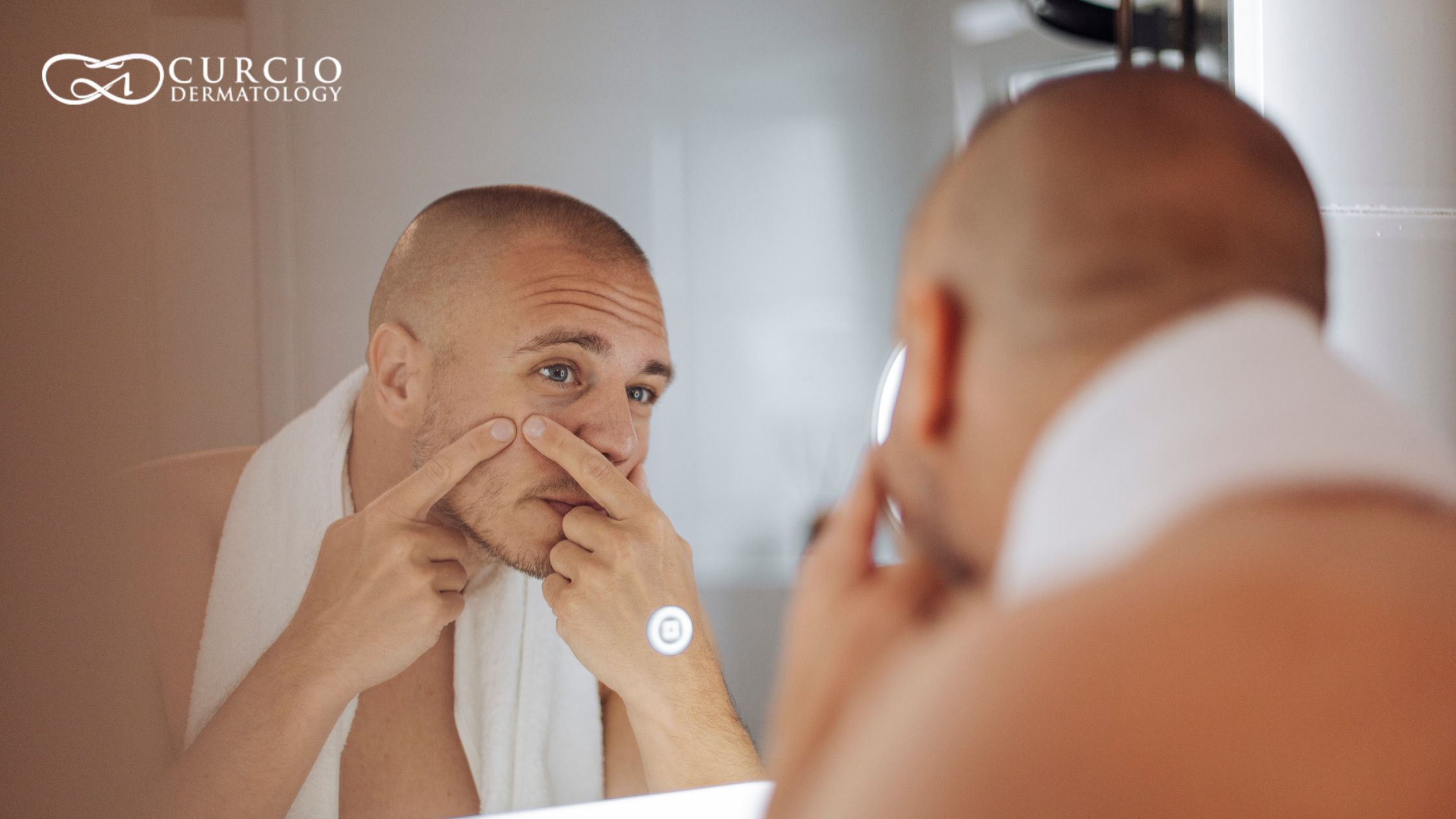 Man examining facial acne and skin breakouts in a bathroom mirror
